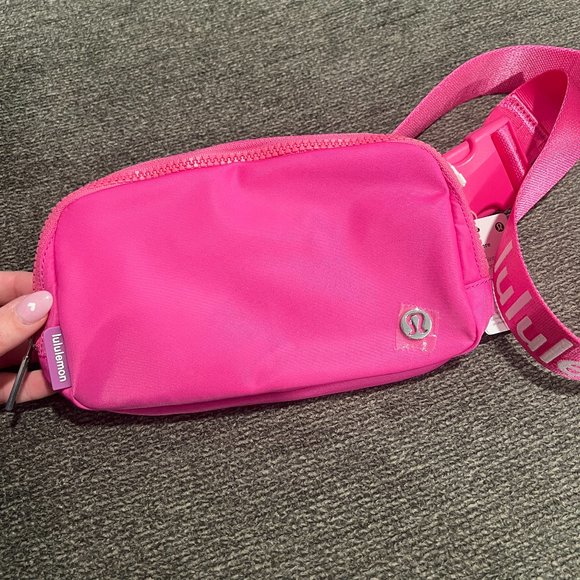NWT Lululemon Everywhere Belt Bag in Sonic Pink with White Letters. Size is 1L